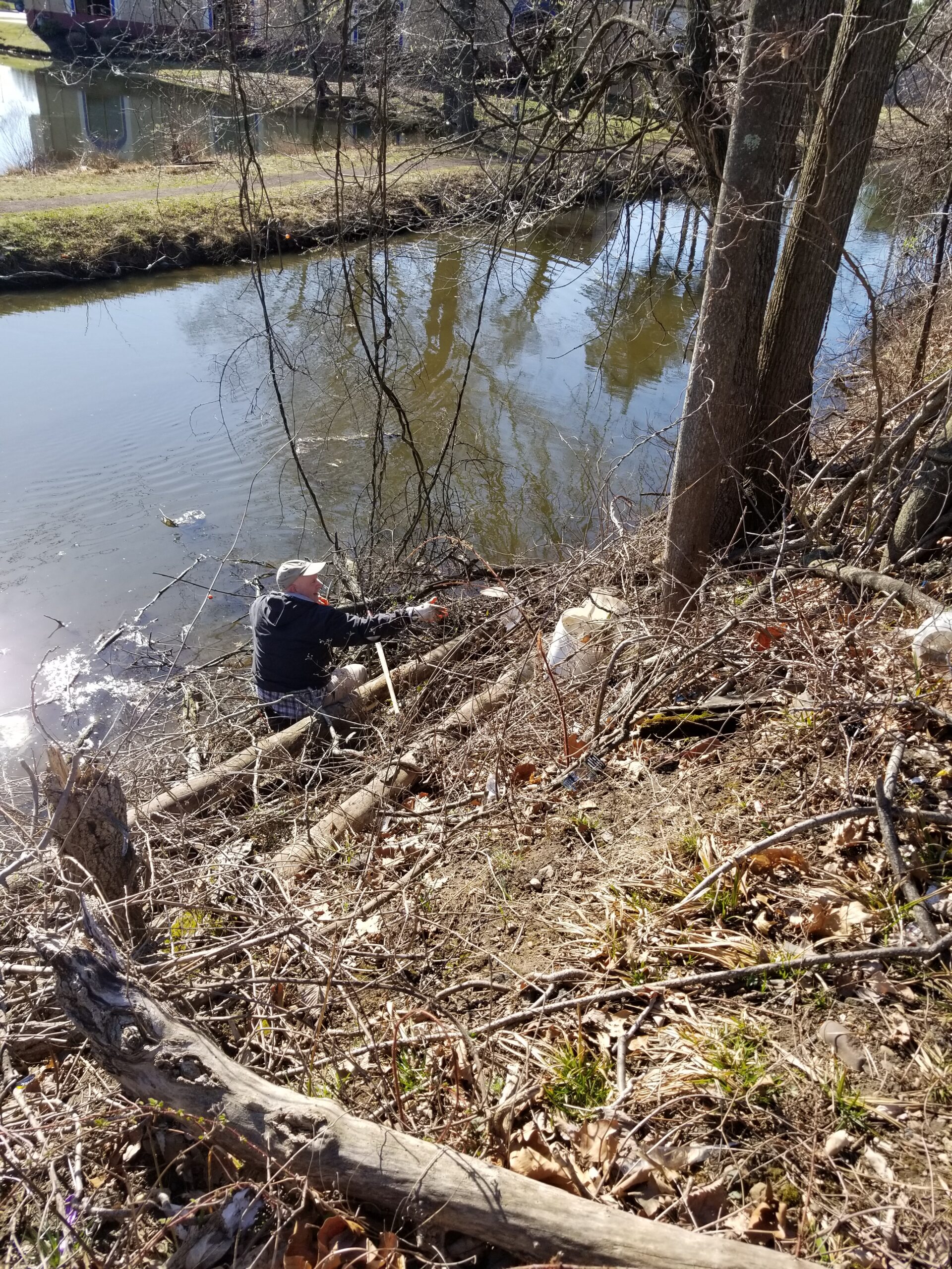 Volunteer cleaning debris from the Delaware Canal